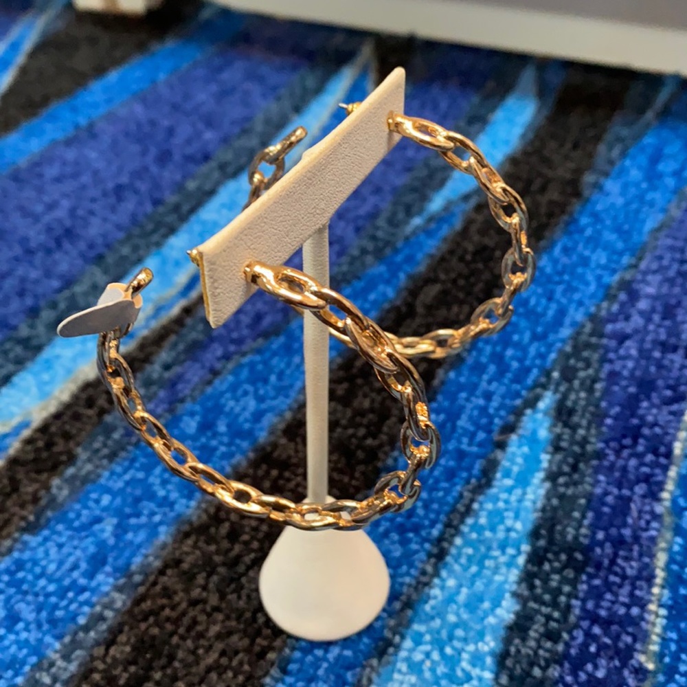 Shiny gold chain link hoop earrings.